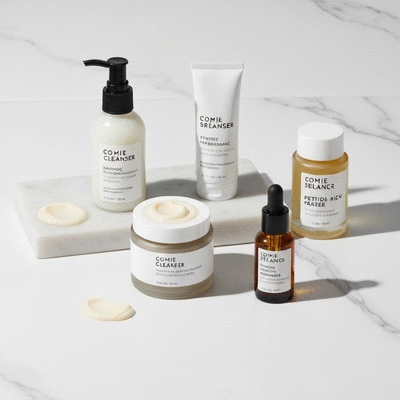 Close-up of various skincare products like cleanser, moisturizer, and sunscreen on a clean white background, emphasizing a proactive routine.